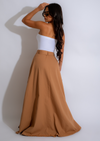 A side view of The Utility Skirt Brown, highlighting its functional pockets and adjustable waistband