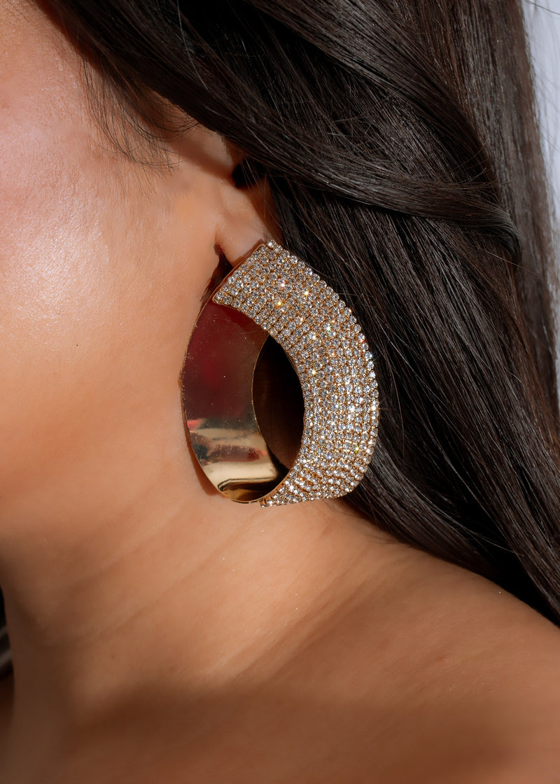 Shimmering gold celestial crescent earrings with intricate detailing and delicate design