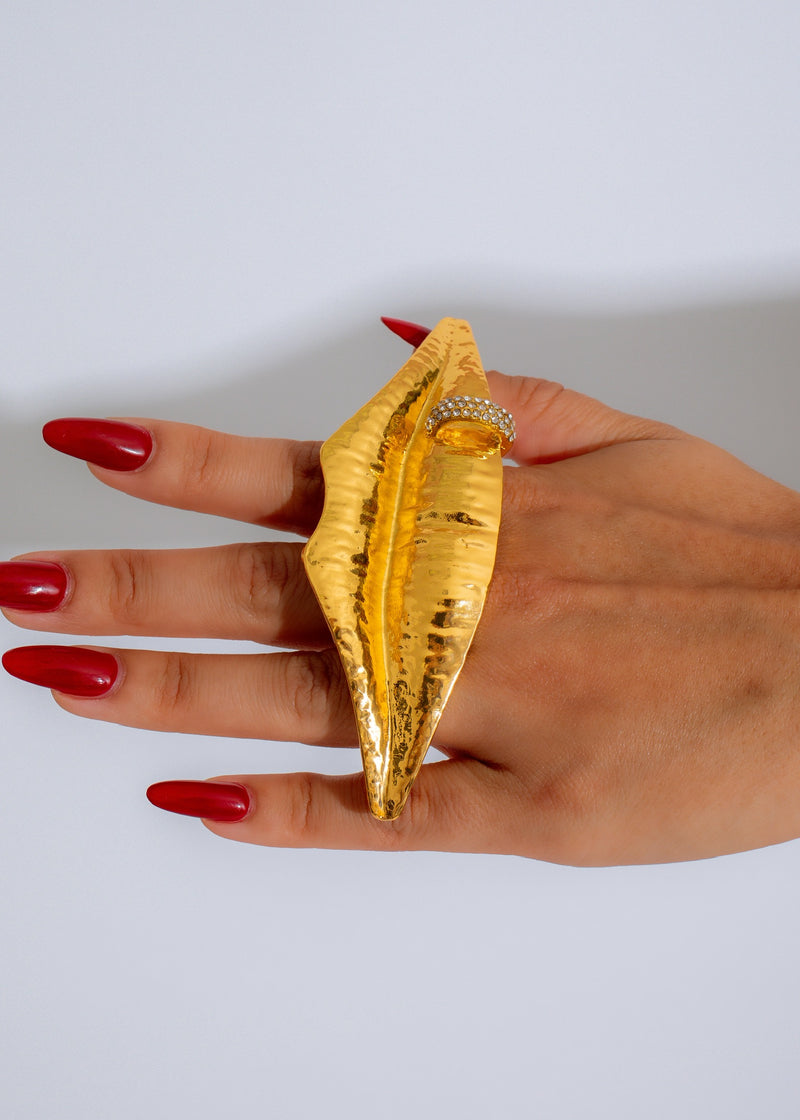 Shiny gold statement ring with Solaris lips design, a bold and stylish accessory