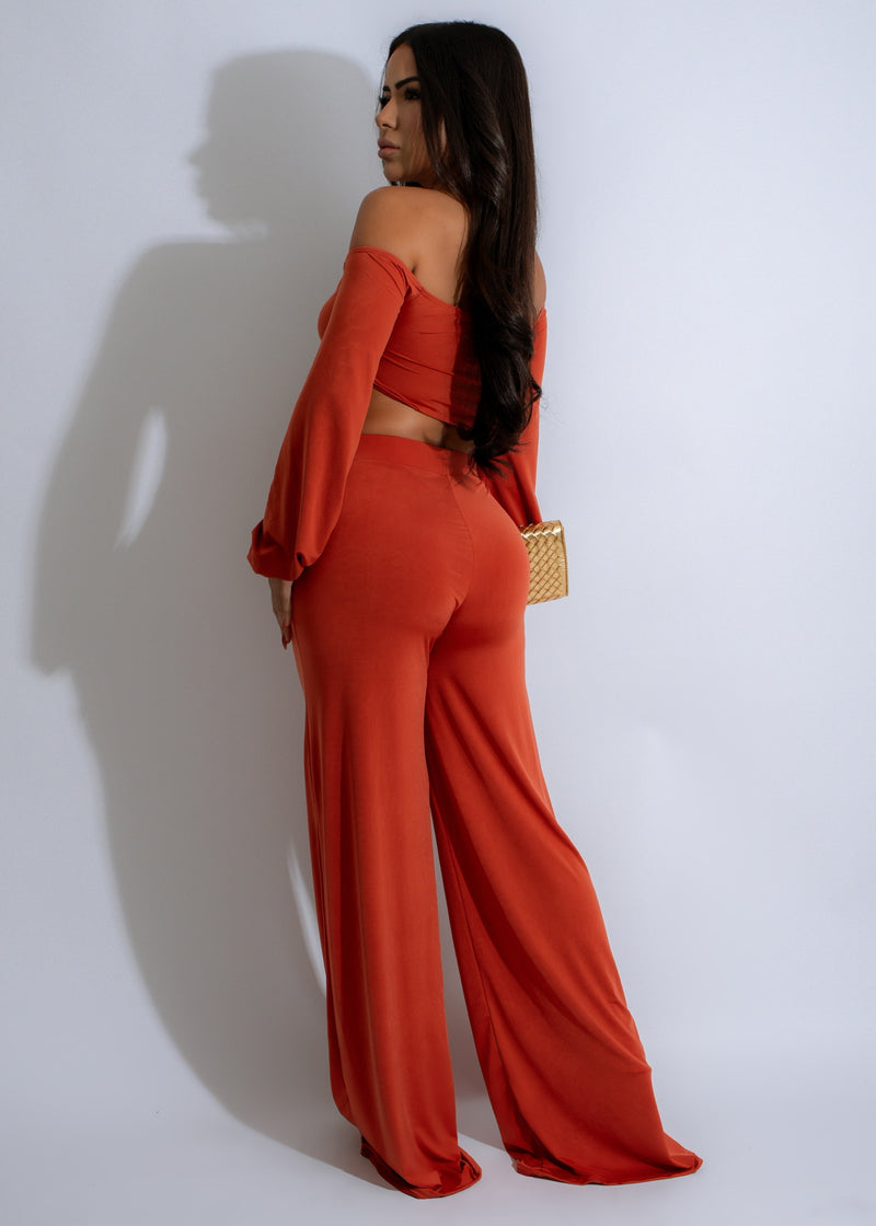  Two-piece pant set featuring a flowy top and wide-leg pants in sunset hues