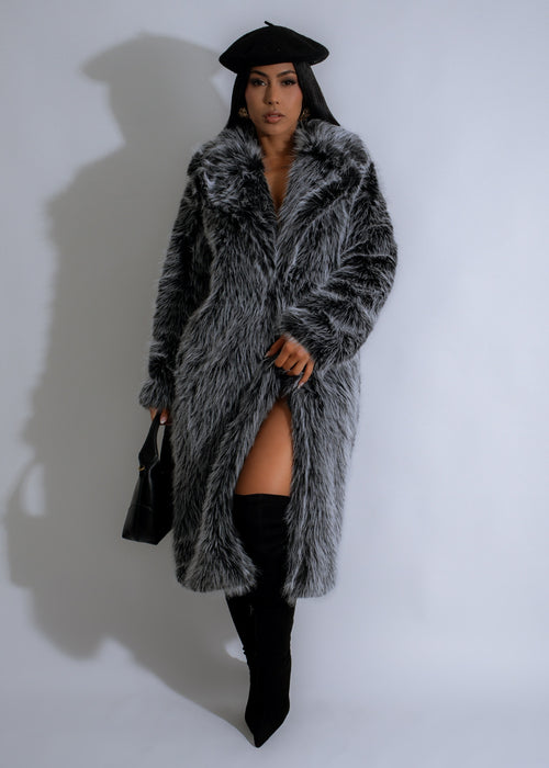 Close-up of luxurious black faux fur coat with storm collar and pockets