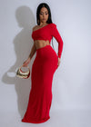 Stunning red Ember Flow Maxi Dress on a woman walking through a vibrant garden