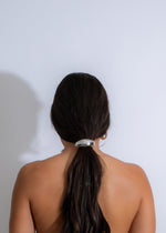  Shiny silver hair tie with a delicate crescent moon design, adding a touch of elegance to your hairdo