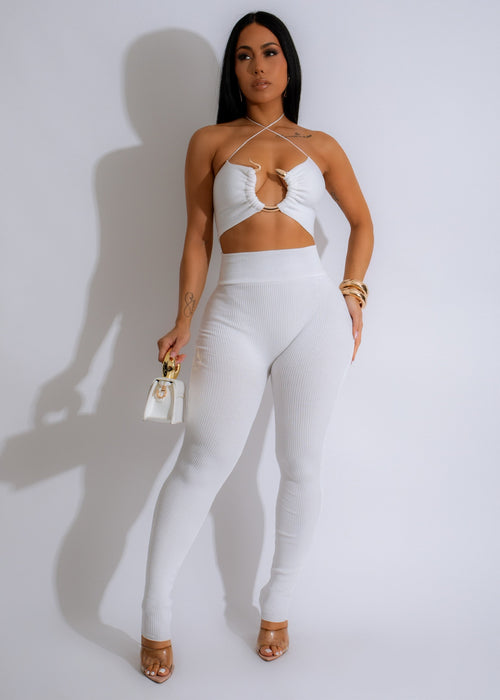 Close up of white ribbed pant set with matching crop top on hanger in natural light 