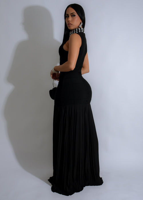  Full-length view of a woman wearing the Regal Glow Ribbed Rhinestones Maxi Dress in black, showcasing the flattering silhouette and sparkling rhinestone details