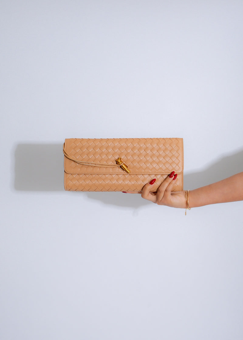 The Woven Grace Clutch Nude, a stylish and versatile accessory for any outfit