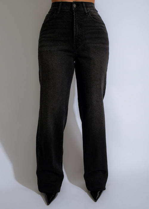 Dark wash denim jeans with fading from thigh to knee