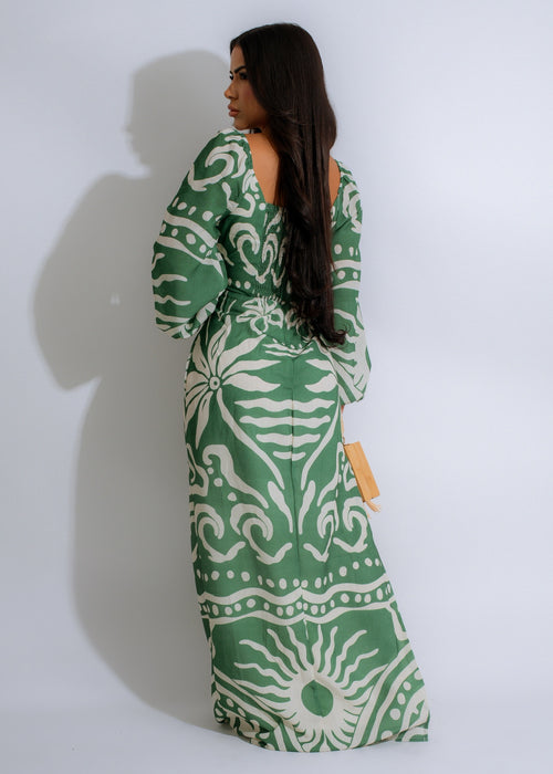 Vibrant green maxi dress with tropical wave pattern flowing in the wind