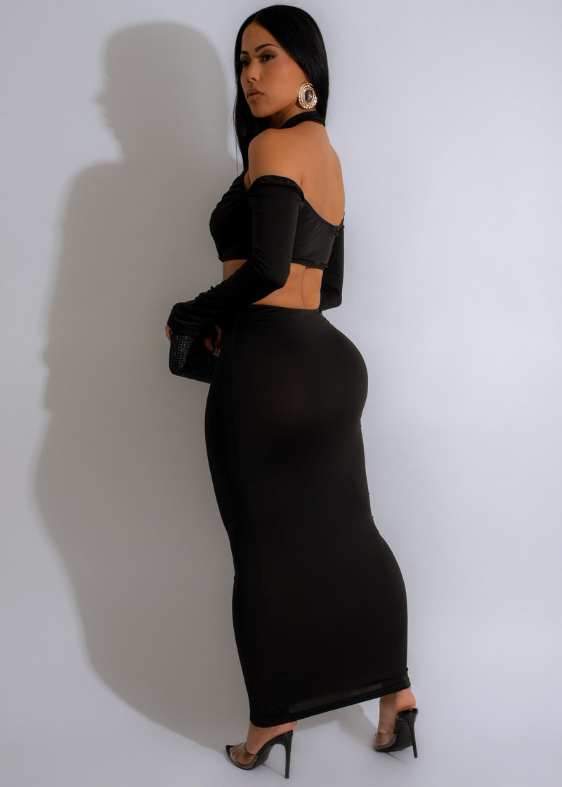 Black maxi dress with cutouts, adjustable straps, and flowy silhouette