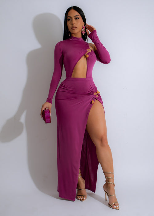 Kiss Me Hard Cut Out Skirt Set Purple, a sexy two-piece outfit with a bold design and vibrant color, perfect for a night out or special occasion The set includes a crop top with cut-out details and a matching skirt with a high slit
