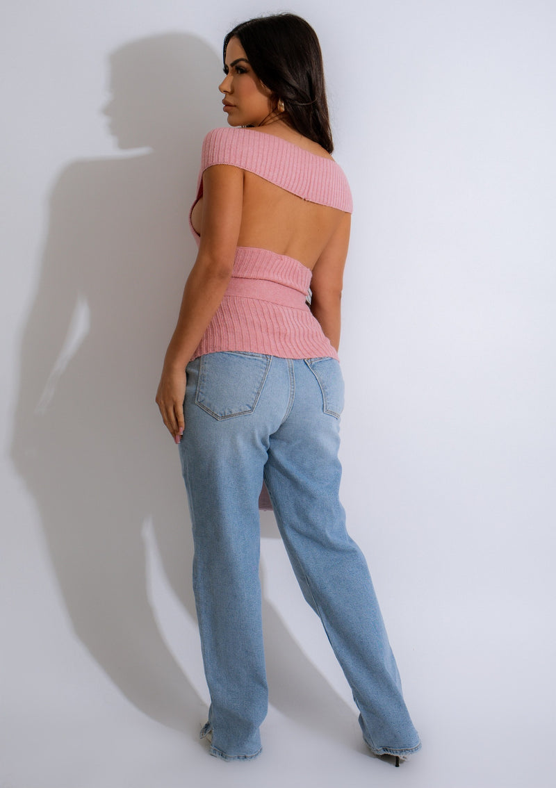 A close-up image of a woman wearing the She's Cozy Knit Top Pink, a soft and comfortable pink knit top with a relaxed fit and ribbed cuffs