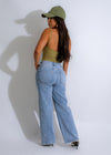  Model in green ribbed bodysuit posing against a white background