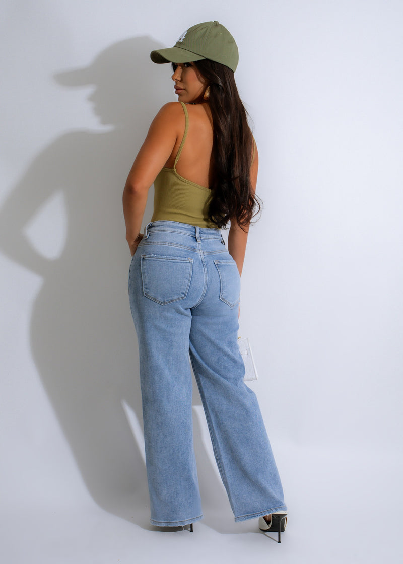  Model in green ribbed bodysuit posing against a white background