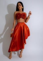 Close-up image of Rosette Reverie Satin Skirt Set Orange, featuring intricate rosette detailing and vibrant orange color 