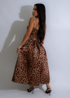  Model wearing Untamed Opulence Rhinestone Midi Dress in brown, showcasing the luxurious fabric, intricate rhinestone details, and flattering midi length design for a stunning and sophisticated look