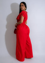  Red jumpsuit with a flattering fit and elegant floral designs, perfect for any occasion