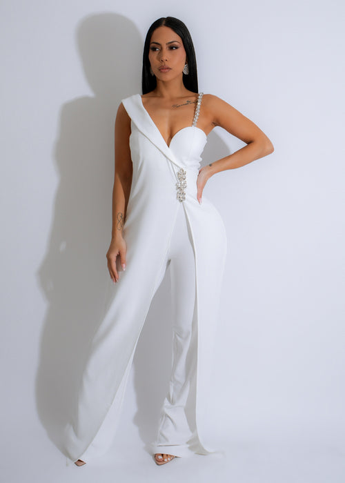 Close-up of white rhinestone jumpsuit with intricate crystal embellishments and elegant design