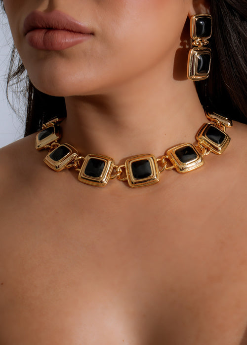 Close-up image of the Regal Essence Necklace Black on a white background, showcasing its intricate silver detailing and elegant black gemstone pendant