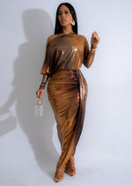 Close-up image of Solaris Drape Ruched Metallic Maxi Dress Gold, showcasing its elegant ruched details and shimmering metallic fabric