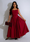 Whispering Rose Maxi Dress Red - Front view of flowy red dress with delicate rose pattern and V-neckline, perfect for summer events and special occasions