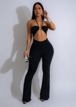 Black cut out jumpsuit featuring a plunging neckline and wide-leg silhouette