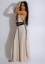 A woman wearing a nude knotted back knit maxi dress