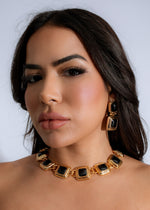  Stylish woman wearing the Regal Essence Necklace Black with a chic black dress, exuding confidence and sophistication