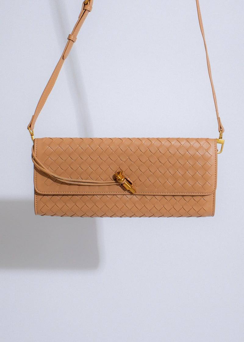 The Woven Grace Clutch Nude, a stylish and elegant accessory for any outfit