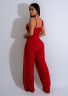  Elegant and eye-catching red jumpsuit adorned with sparkling crystal rhinestones, a stunning choice for a formal event or night out