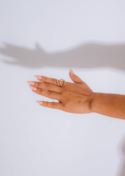  Close-up of a hand wearing an elegant Infinity Loop Ring Gold