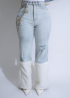 Light denim high-waisted ripped jeans with a distressed finish by Alpine Luxe