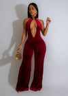 Velvet Nights Jumpsuit Red on model standing in front of city lights at night