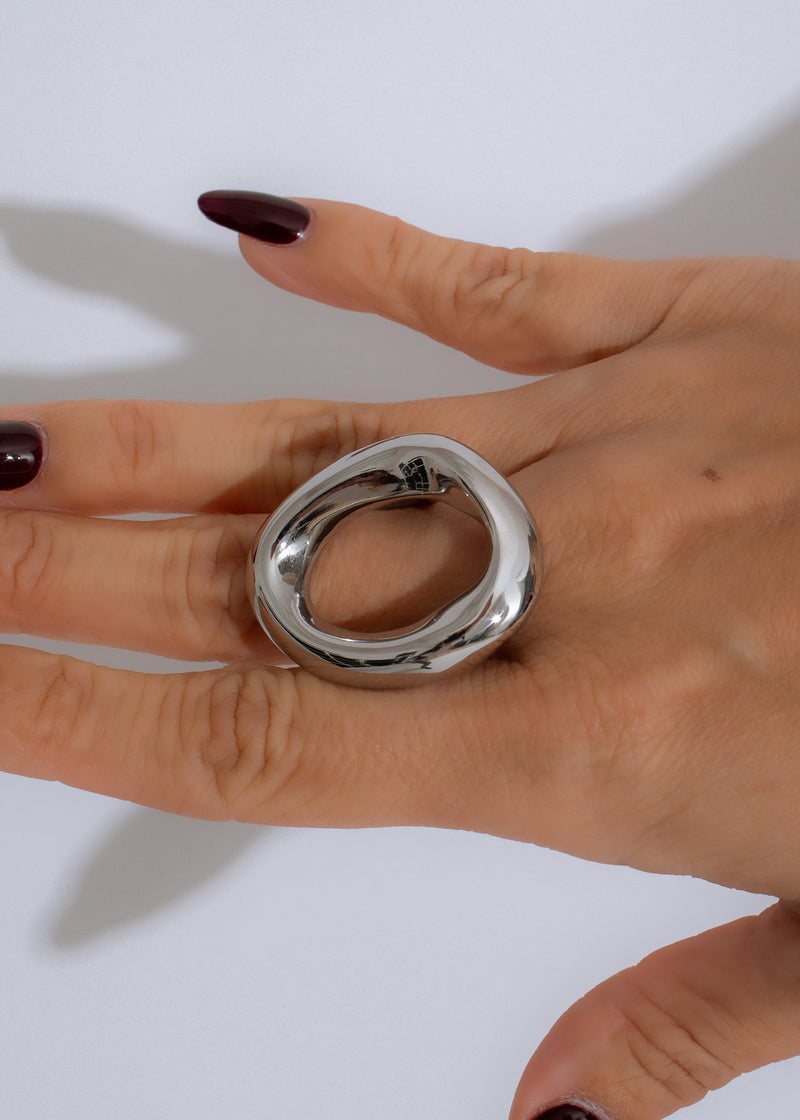 Shiny silver infinity wave ring with intricate details and polished finish