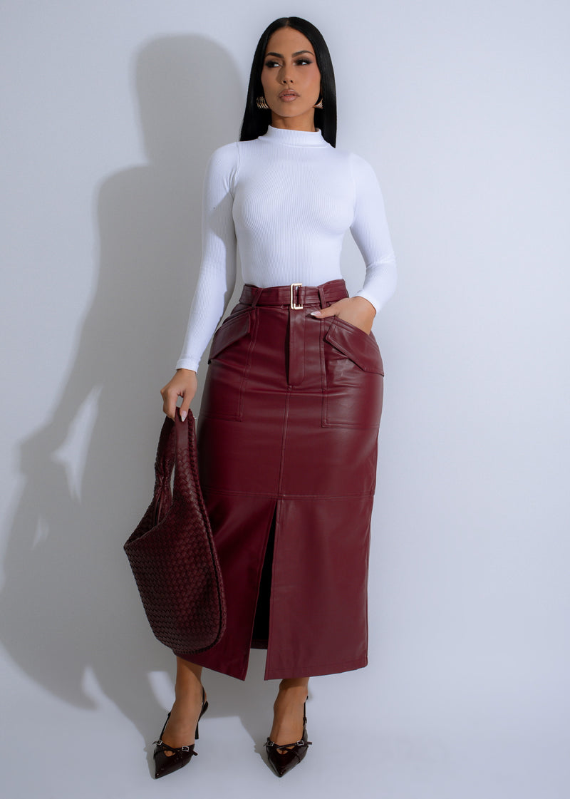 Close-up of red faux leather skirt with utility pockets and belt detail