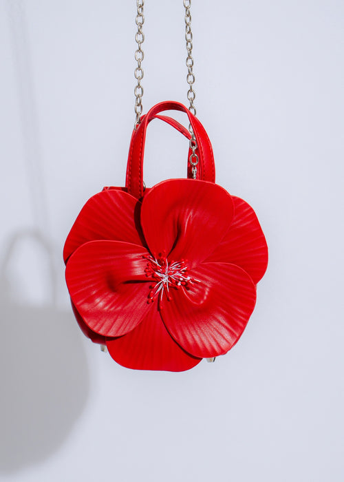 Stylish and elegant red handbag with intricate petal design