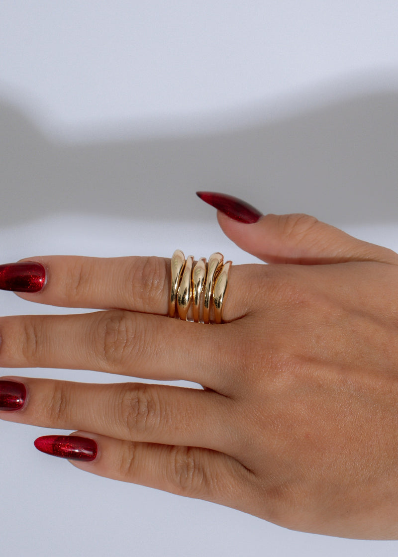 Shiny gold cascade band ring with intricate twist design and elegant finish