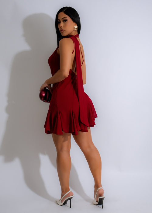  Model wearing the Starlight Whisper Mini Dress in red, showcasing the flattering fit and luxurious feel of the fabric, a stylish and sophisticated choice for any event