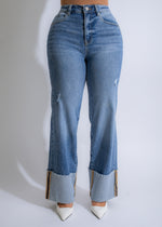 Cuffed light denim jeans with distressed detailing and frayed edges