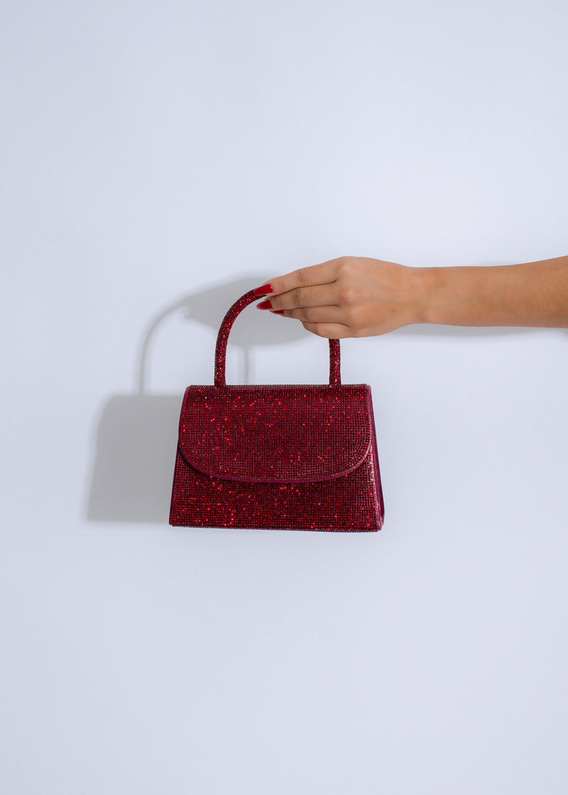 Close-up of red Sparkle Allure rhinestones handbag with intricate beaded design and gold chain strap 