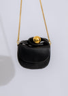 Stylish and elegant black faux leather handbag with spacious interior compartment