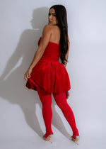 Full-length image of a woman posing in a red Buttercup Velvet Mini Dress featuring a flared skirt, V-neckline, and a low back, styled with a matching clutch and bold lipstick