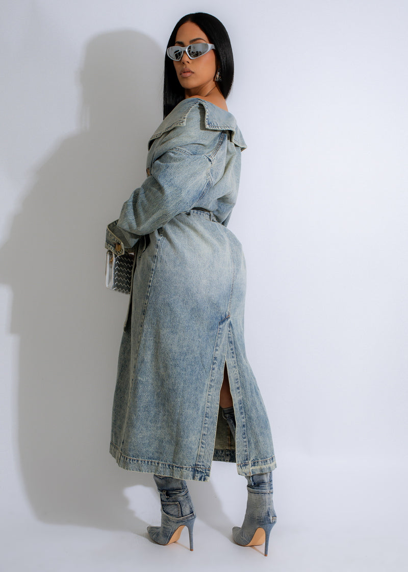 A photo of a woman wearing the Faded Horizon Coat Light Denim, a trendy and fashionable option