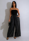 Front view of black denim jumpsuit with button-up front and belt