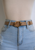 Close-up image of the Oval Allure Belt Nude, showcasing its elegant oval-shaped buckle and soft nude leather material 