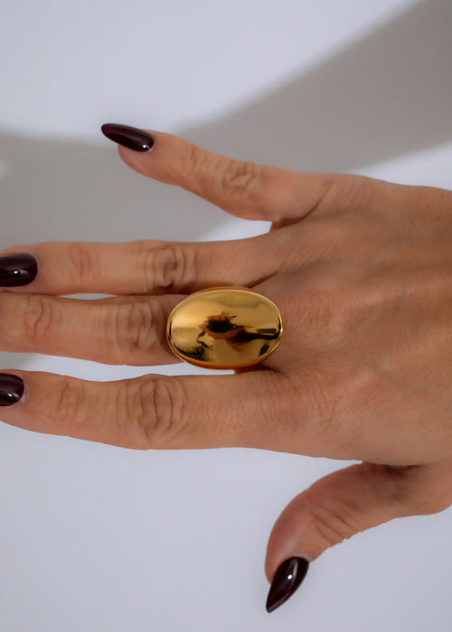 Shimmering gold ring with intricate elemental design, perfect for elegant accessorizing