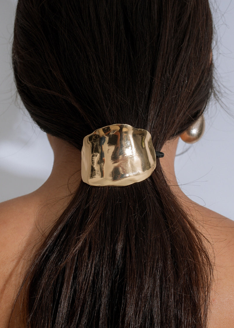 Radiant Hold Hair Tie Gold on a woman's brunette ponytail 