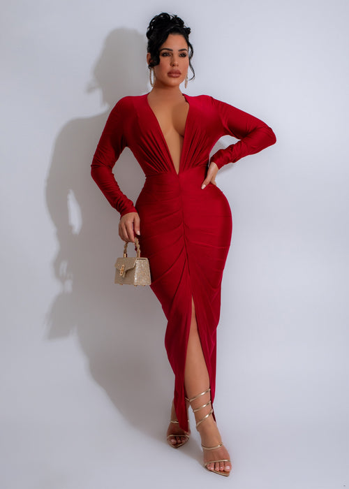 Close-up of the elegant red ruched maxi dress with a side slit and off-shoulder neckline, perfect for formal evening events or special occasions