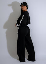  Full-body image of a woman walking in the Street Pulse Stripes Pant Set Black, showcasing the sleek and modern look of the outfit