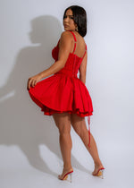 Red lace mini dress with delicate charm detailing and a breezy silhouette