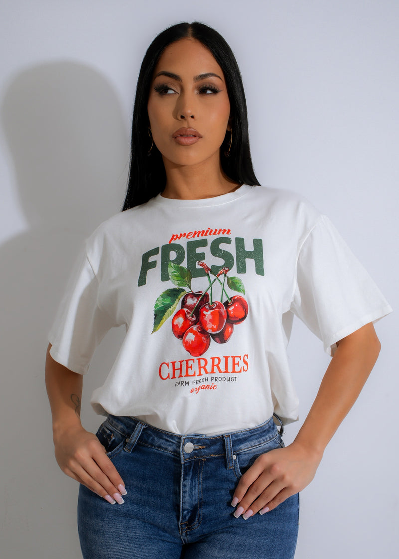 Front view of Summer Harvest T-Shirt White on a hanger in natural sunlight